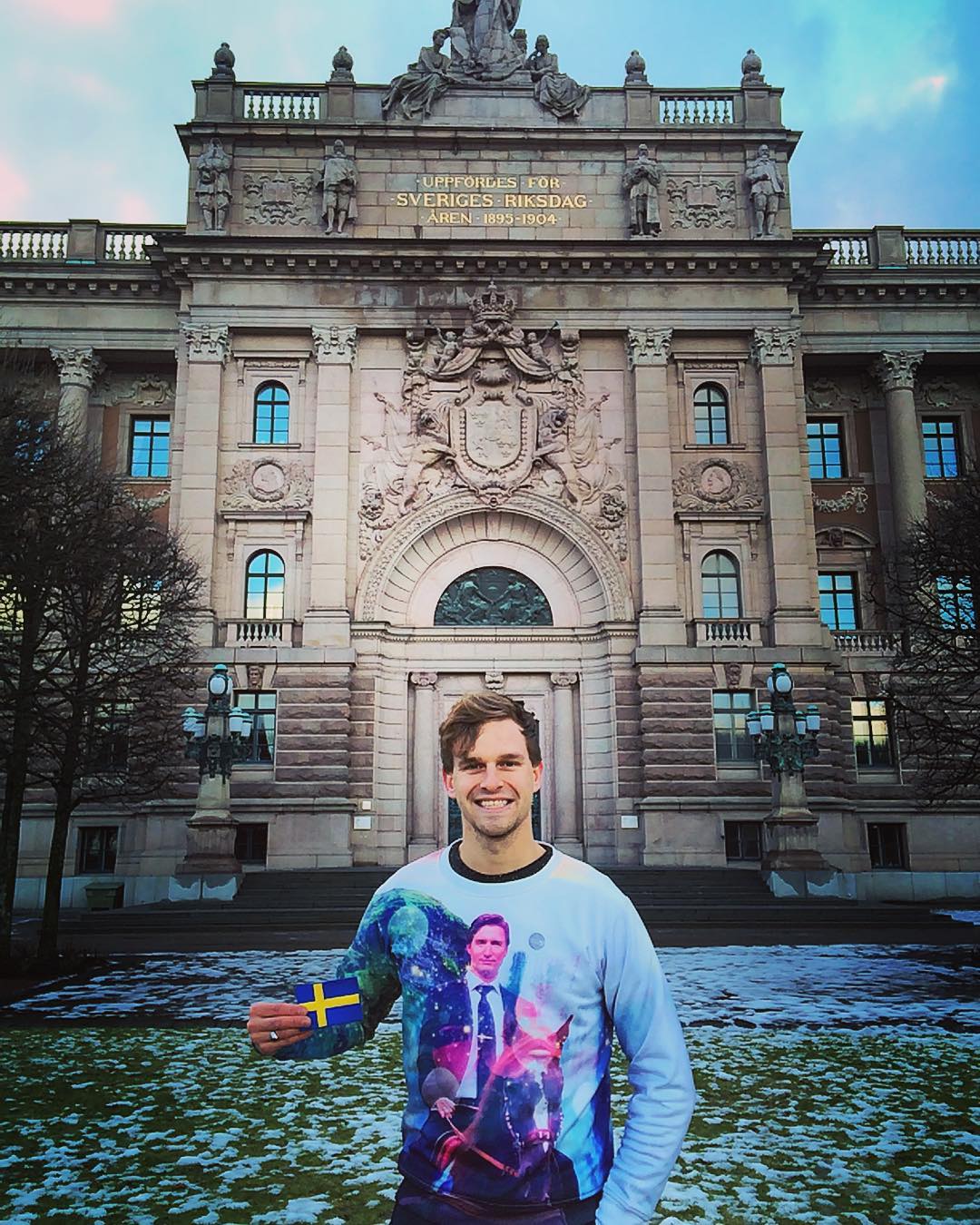 Guy with Swedish Flag in front of old building Stockholm