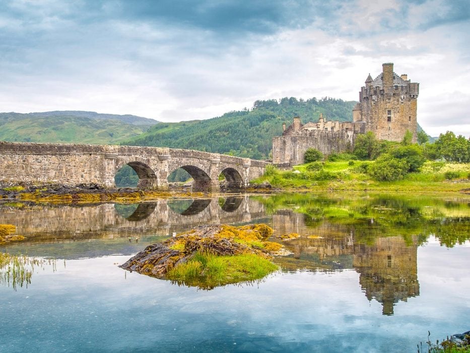 Altes Schloss aus Stein mit grünem Gras und Wasser schottisches Hochland