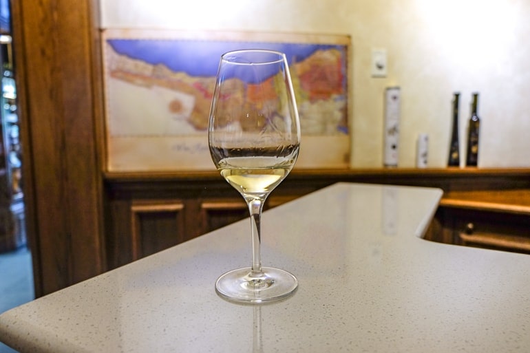 wine glass with ice wine on counter inside a winery