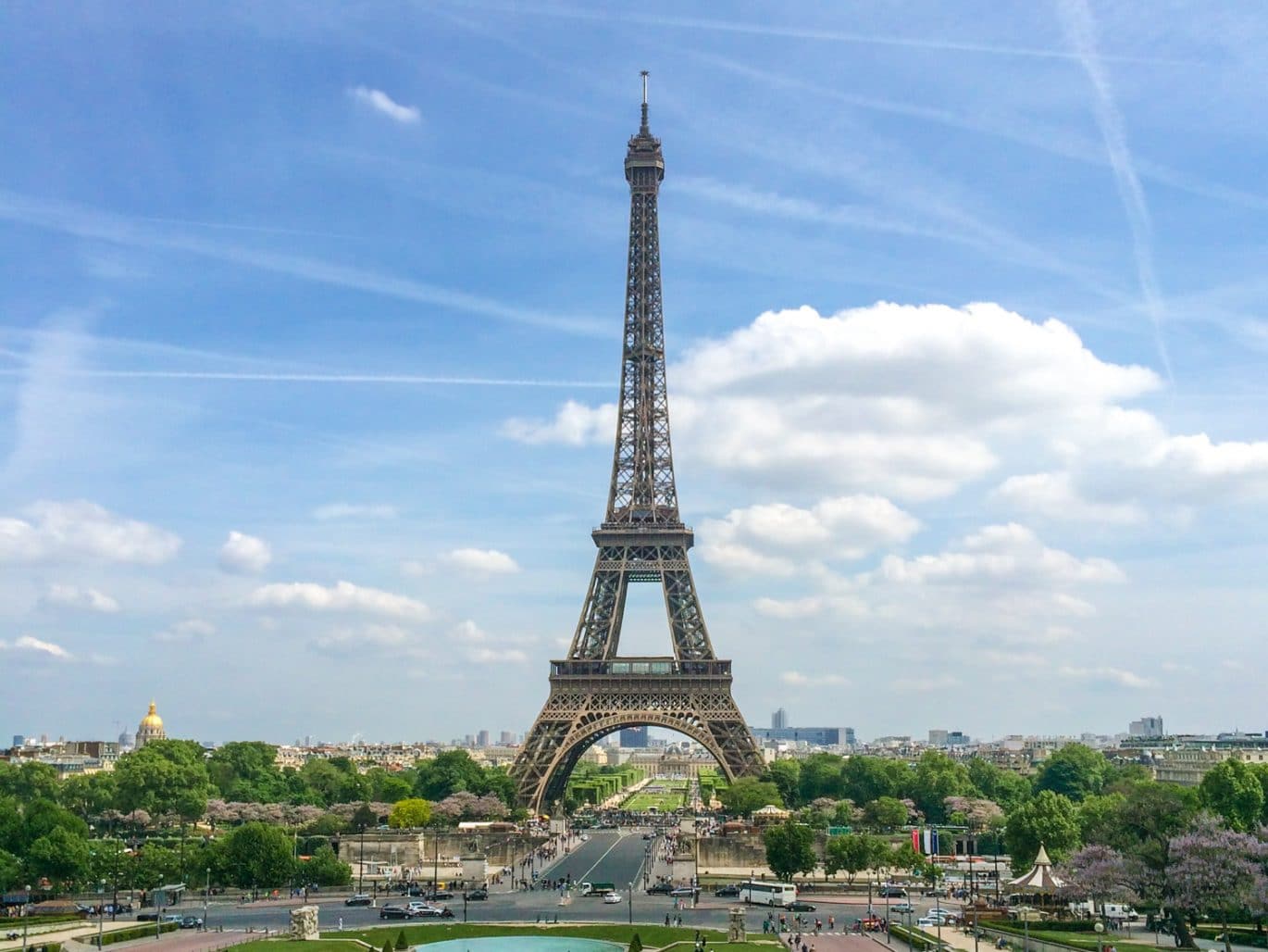 eiffel tower with blue sky and green trees europe trip itinerary