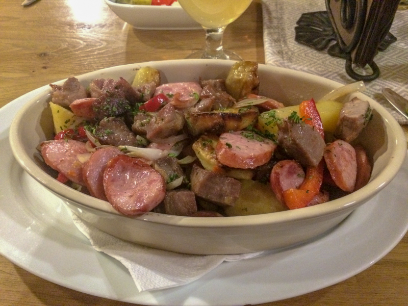 sausage and potato dish in white bowl