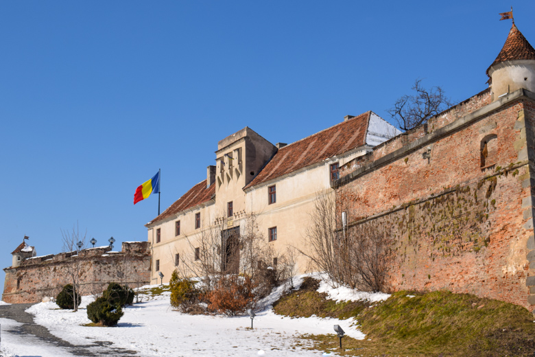 citadel with flag atop hill with blue sky