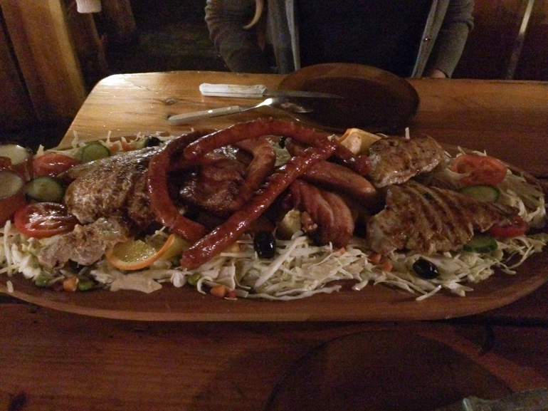 meat and food platter on wooden table bucharest romania penguin and pia