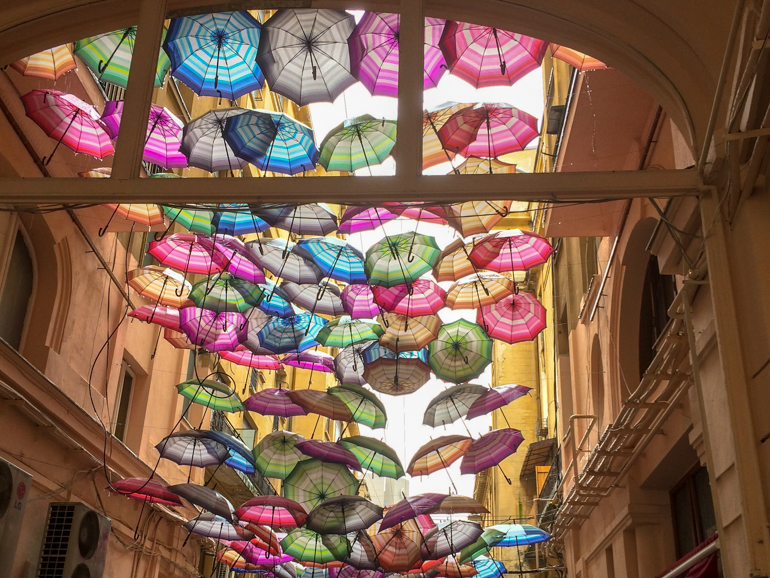 colourful umbrellas hanging in alley in bucharest romania