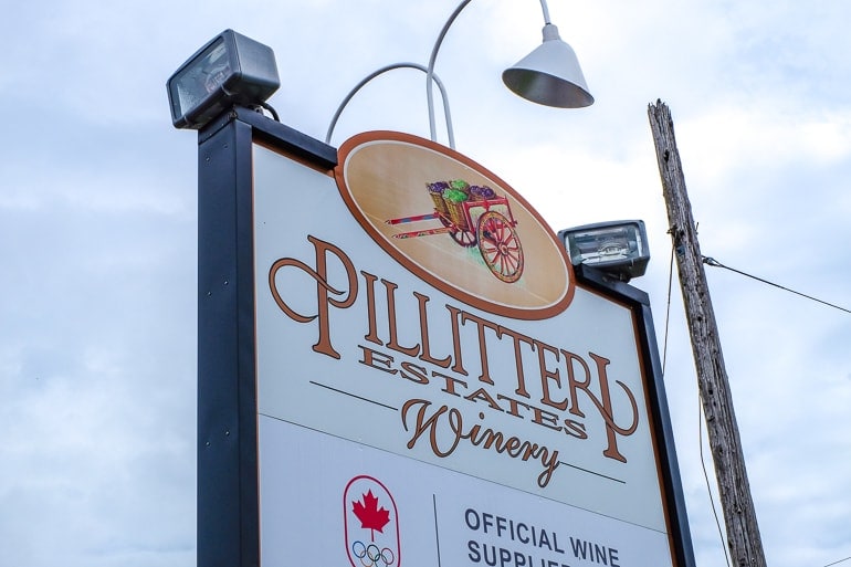 white sign with winery name by roadside niagara on the lake