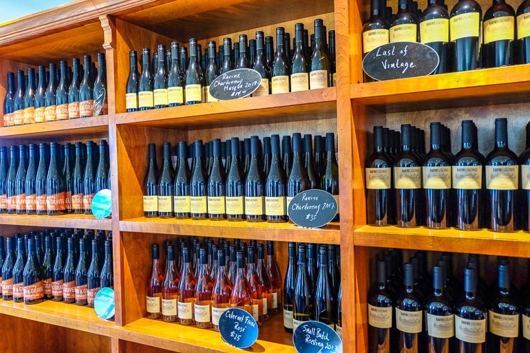 wine bottles on wooden shelves at ravine winery