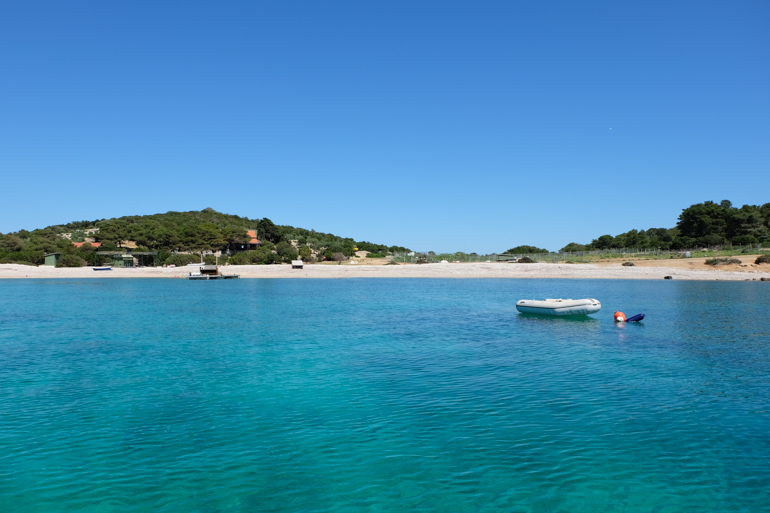 crystal blue waters and rocky beach in croatia island hopping