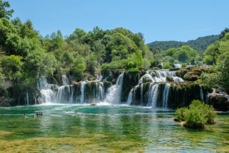 waterfall in croatia with green trees and blue sky krka national park