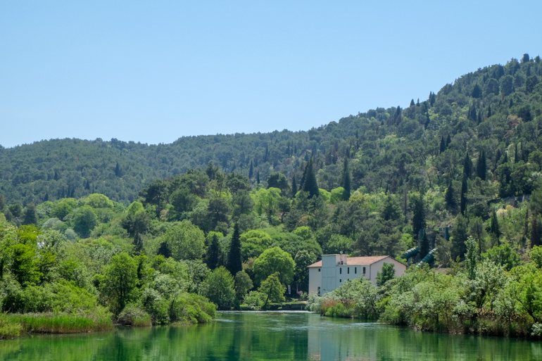 building in trees by river side close to Krka national park