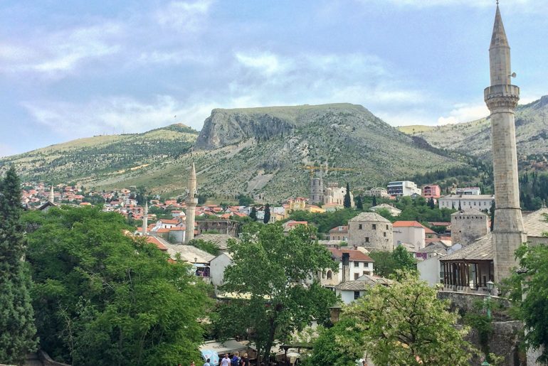 mosque towers and old town with blue sky in mostar things to do in mostar