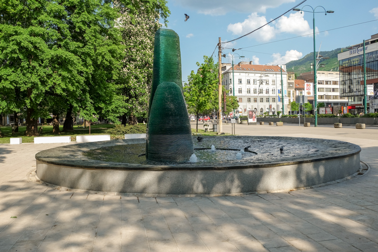 green statue in fountain in sarajevo