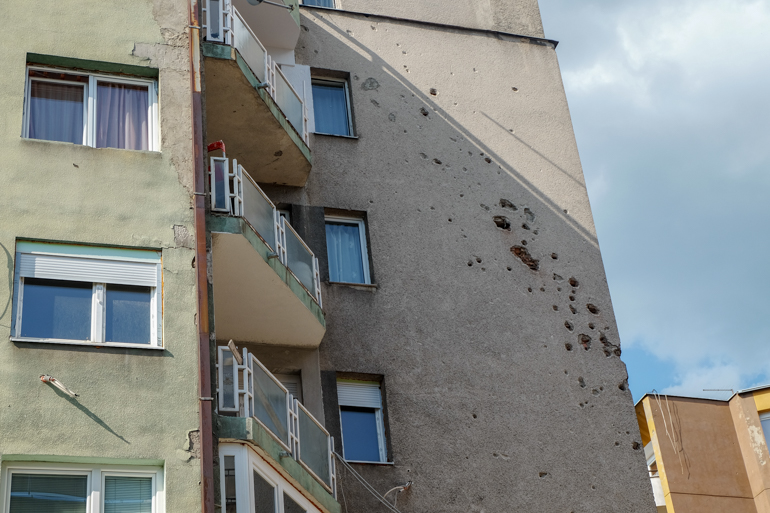 apartment building in sarajevo with shrapnel holes