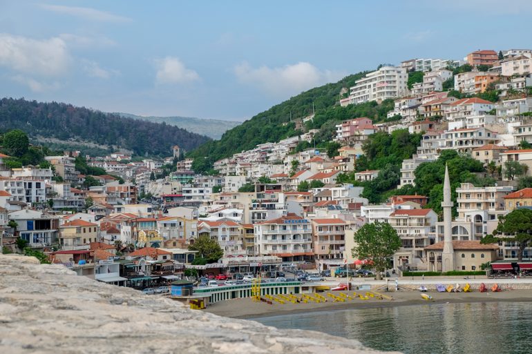 sandy beach with many buildings facing bay in ulcinj montenegro