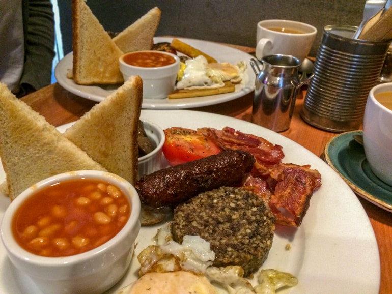 full scottish breakfast with beans and toast and coffee in coffee shop in edinburgh