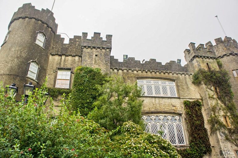 castle with turrets and green trees ireland travel tips