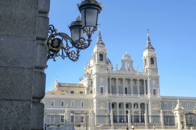 white cathedral with street light in front things to do in madrid