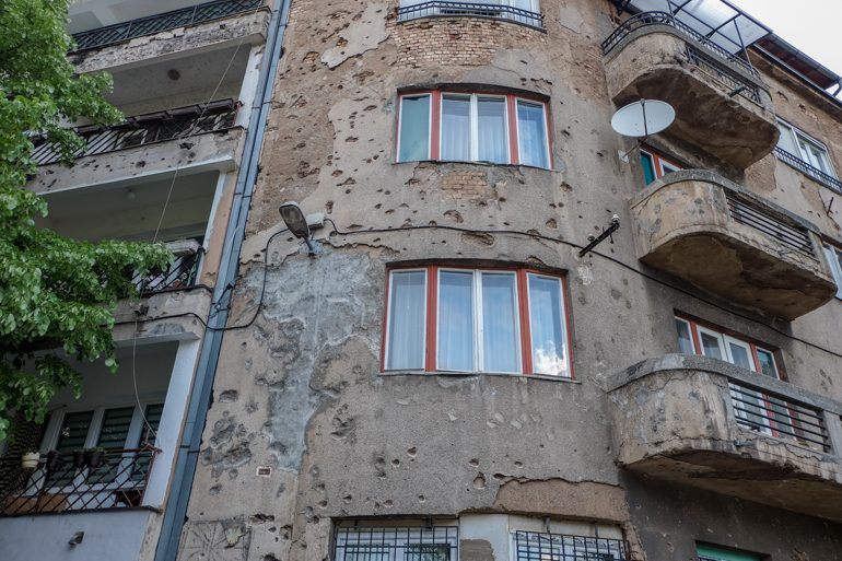 machine gun holes on apartment building in Sarajevo bosnia and herzegovina travel