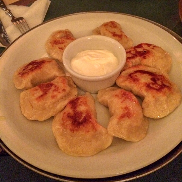 pierogies on a white plate on green table 3 days in krakow
