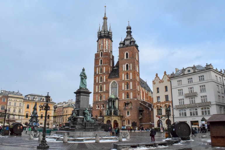 st marys red brick basilica basilica with statue in front in krakow main square 3 days in krakow