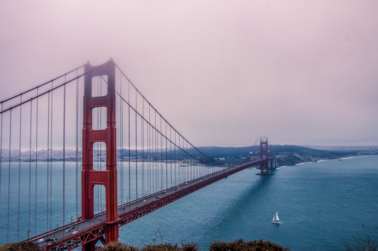 golden gate bridge in thick fog with blue water under san francisco insider tips