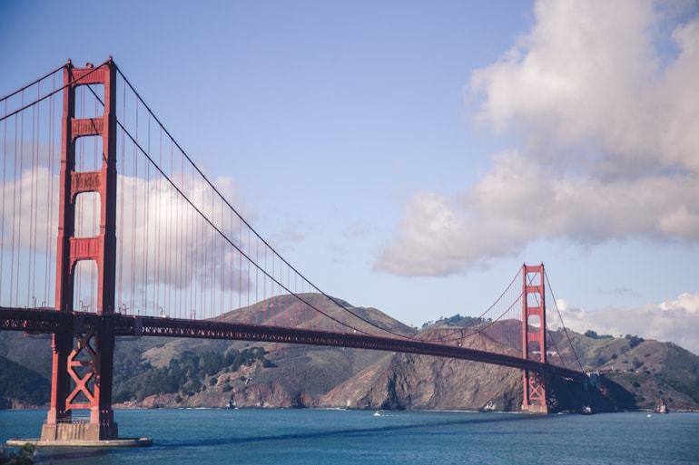 golden gate bridge with blue water under and blue sky white clouds in san francisco insider tips