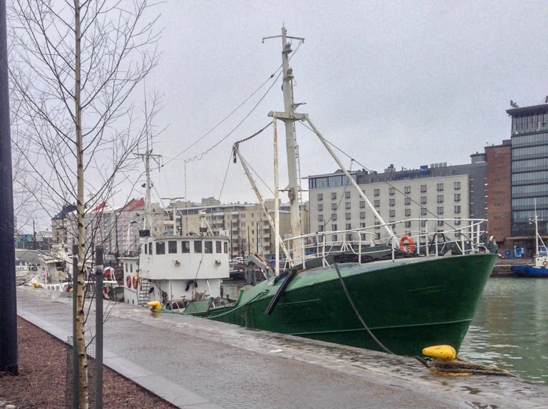 green boat tied up on pier in helsinki tallinn to helsinki ferry