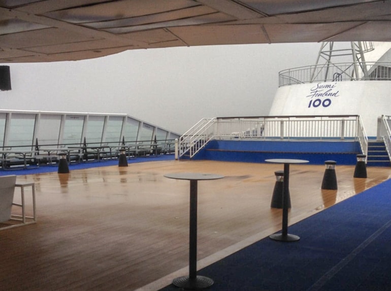 exterior top deck of ferry with blue carpet and railing tallinn to helsinki ferry
