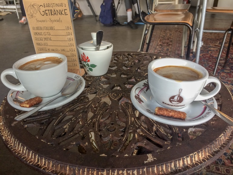 white coffee mugs on round iron table.