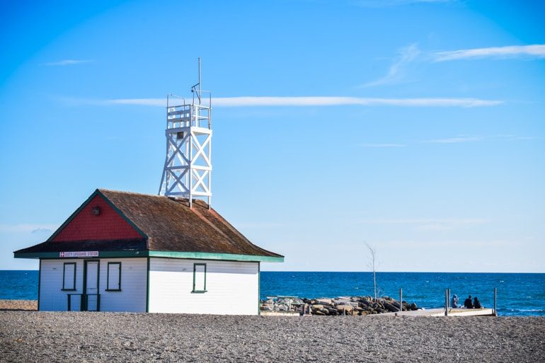 white wooden lifeguard with tower and blue sky and water travelling to canada for the first time