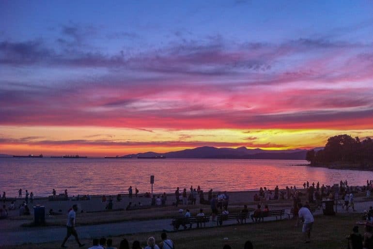 colourful sunset over water at english bay west end in vancouver