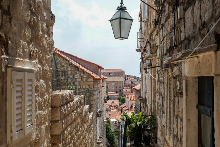 street lamp in stone alley overlooking old town things to do in dubrovnik croatia
