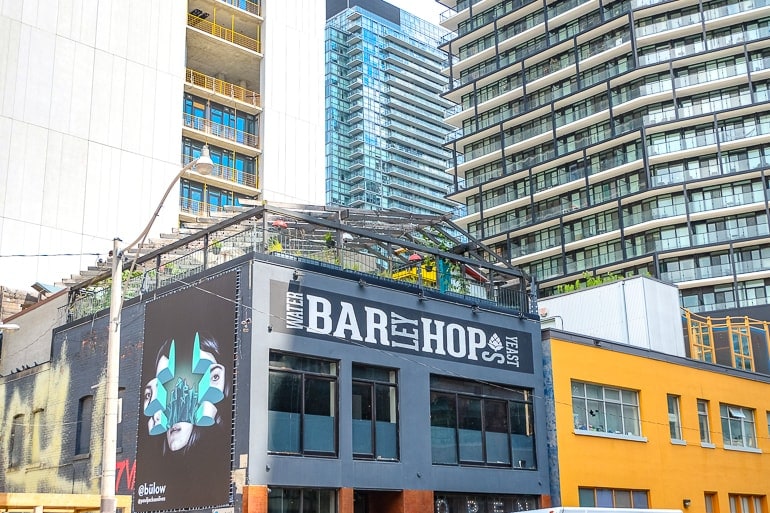 bar with rooftop patio and tall buildings behind in downtown toronto.