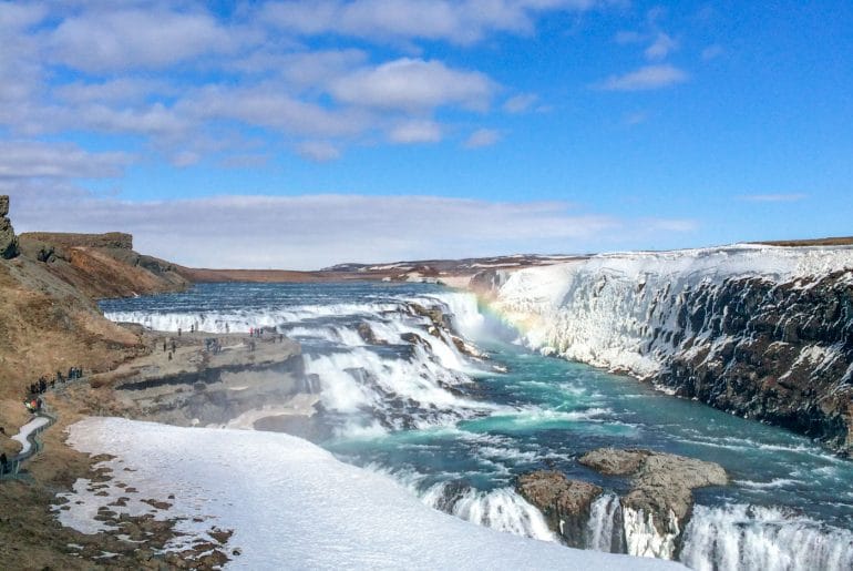 waterfall with blue water and rainbow golden circle tour iceland gullfoss