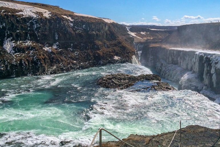 blue and white water with rock cliffs of water fall gullfoss golden circle tour iceland