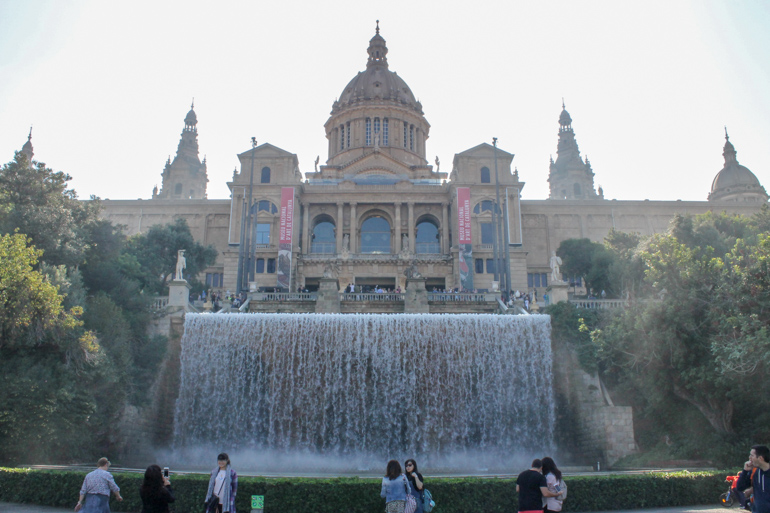 large museum with domes tops and fountain in front places to visit in barcelona