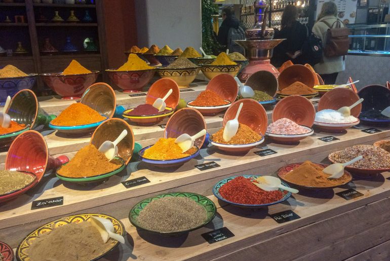 bowls of colourful spices on shelf at market things to do in eindhoven
