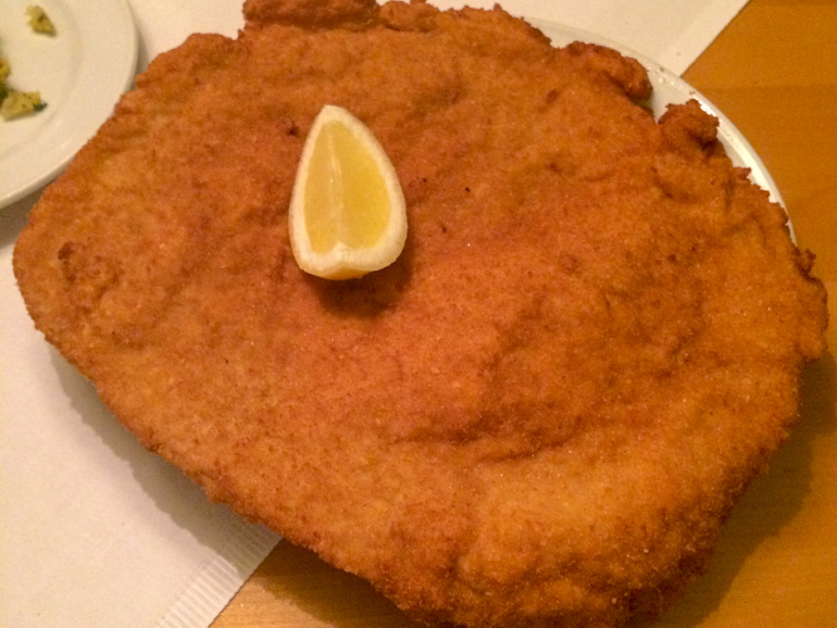 breaded schnitzel on plate with lemon things to do in vienna