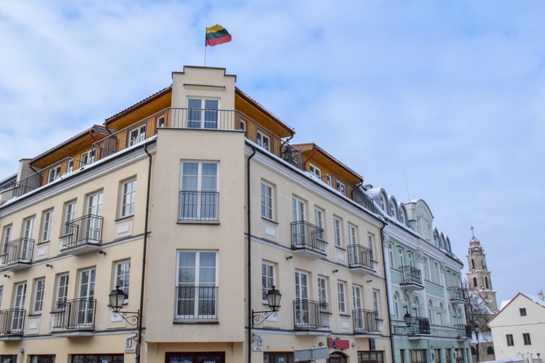 old colourful building with Lithuanian flag on top travelling the baltics