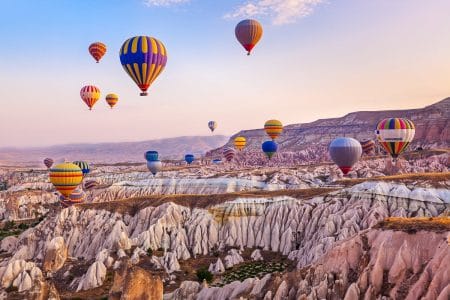 hot air balloons over pink rocky landscape turkey experiences of a lifetime