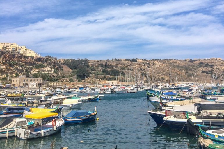 boats in harbour with blue water things to do in gozo
