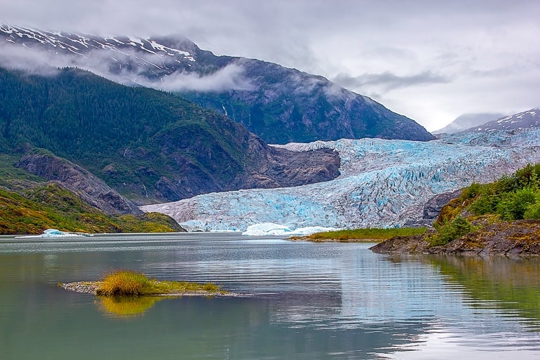 glacier with lake in front and mountain behind in alaska usa