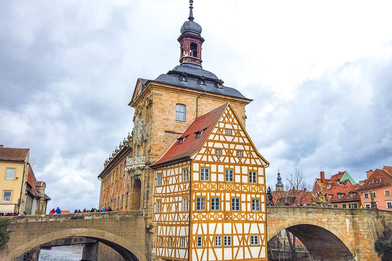 yellow wooden town hall connected to bridge in bamberg germany