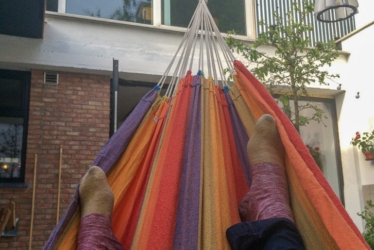 feet in colourful hammock european hostels antwerp belgium