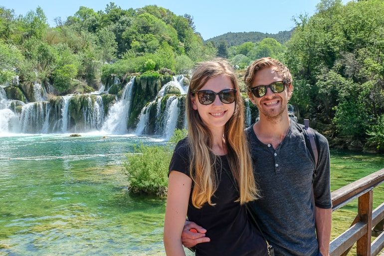 couple in front of waterfall krka national park travelling to europe for the first time