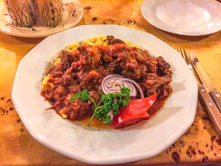 plate of hungarian stew on wood table one day in budapest