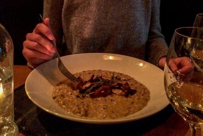 bowl of risotto on table with wine glasses barcola montreal