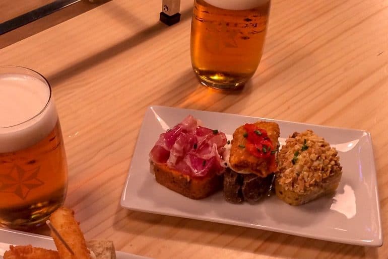 pintxos on a plate with a beer things to do in bilbao spain