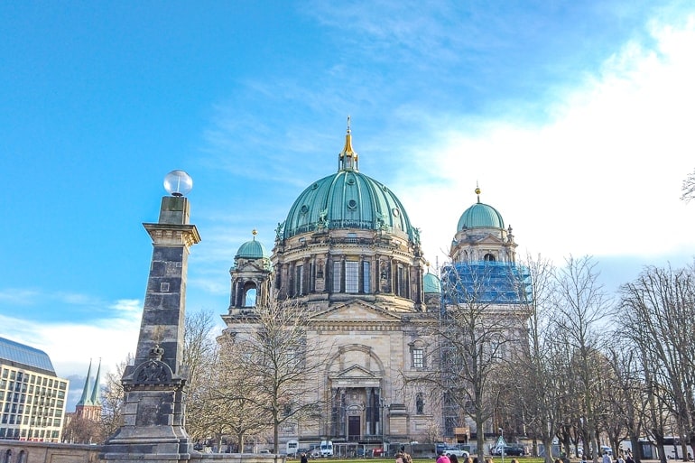 cathedral with green domes and blue sky behind in berlin.