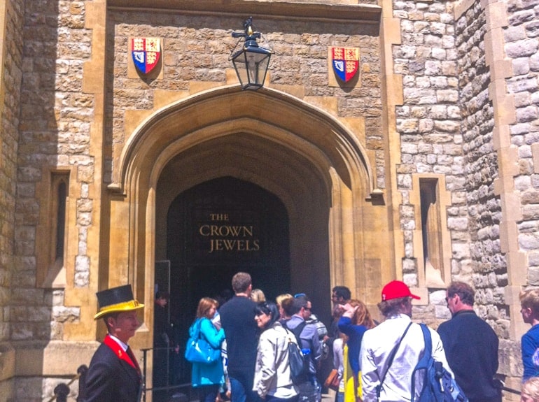 people standing in line waiting to enter crown jewels entrance at tower of london.