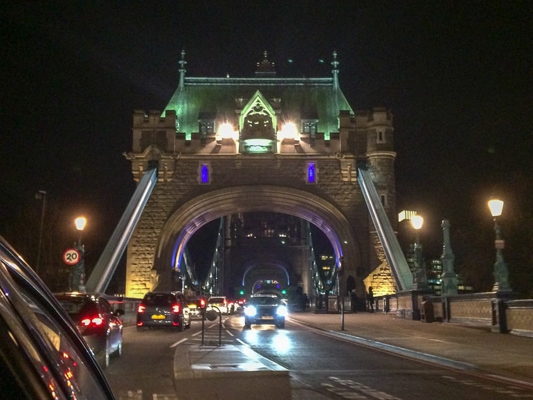 tower bridge at night with cars crossing it one day in london